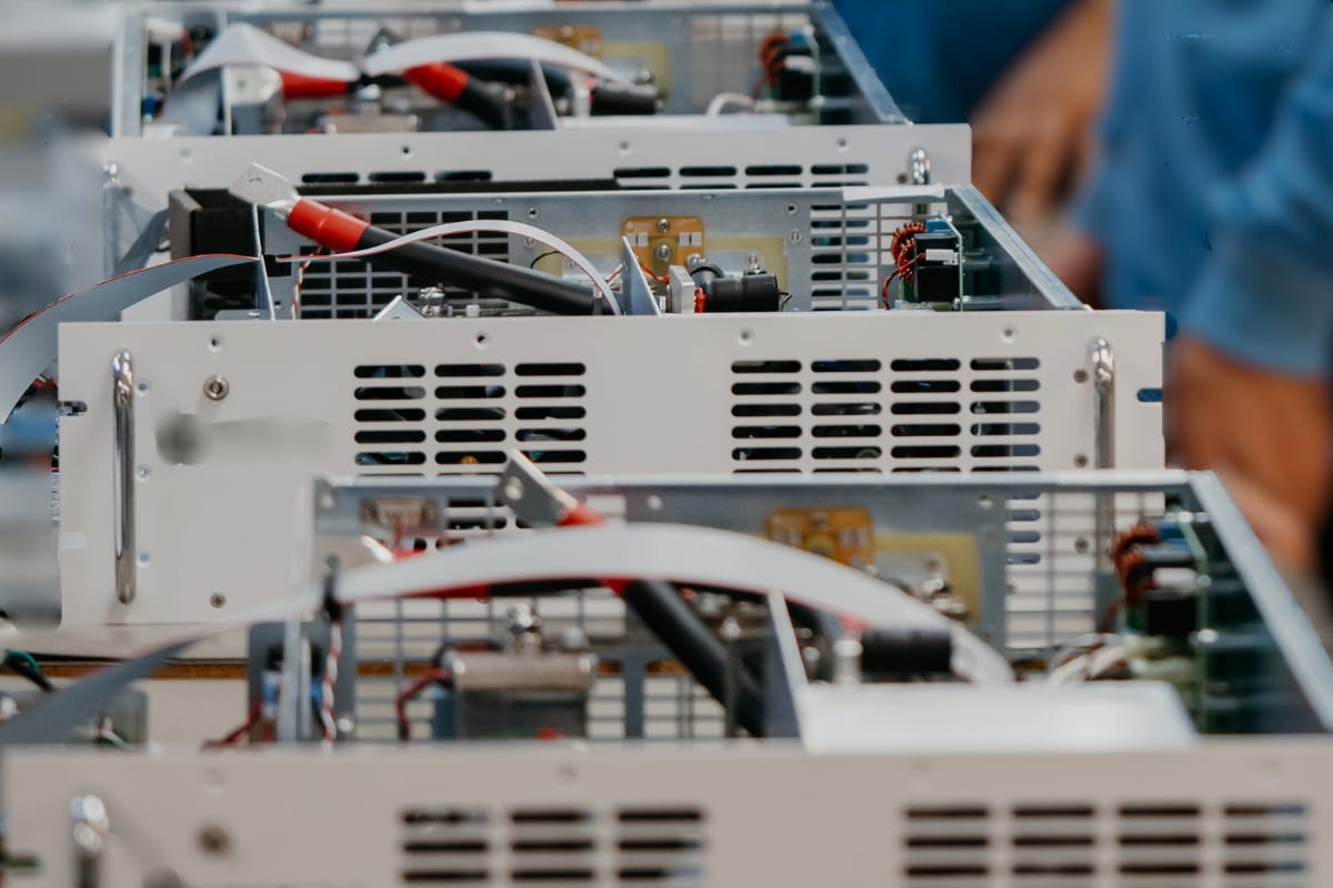 Integrated electronics box build assembly showing PCB, wiring, and sheet metal enclosure during production