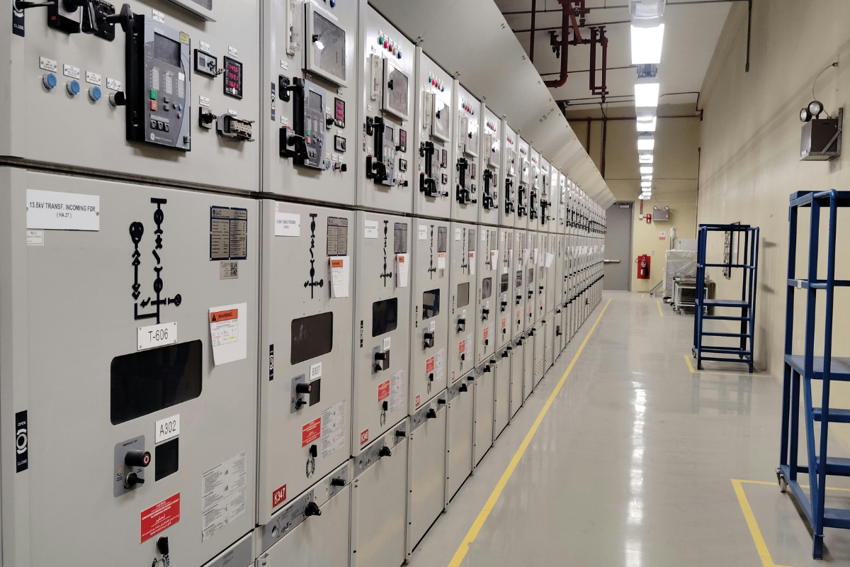 Industrial electrical control panels and enclosures in an energy sector facility, representing ruggedized electronics manufacturing for oil and gas applications