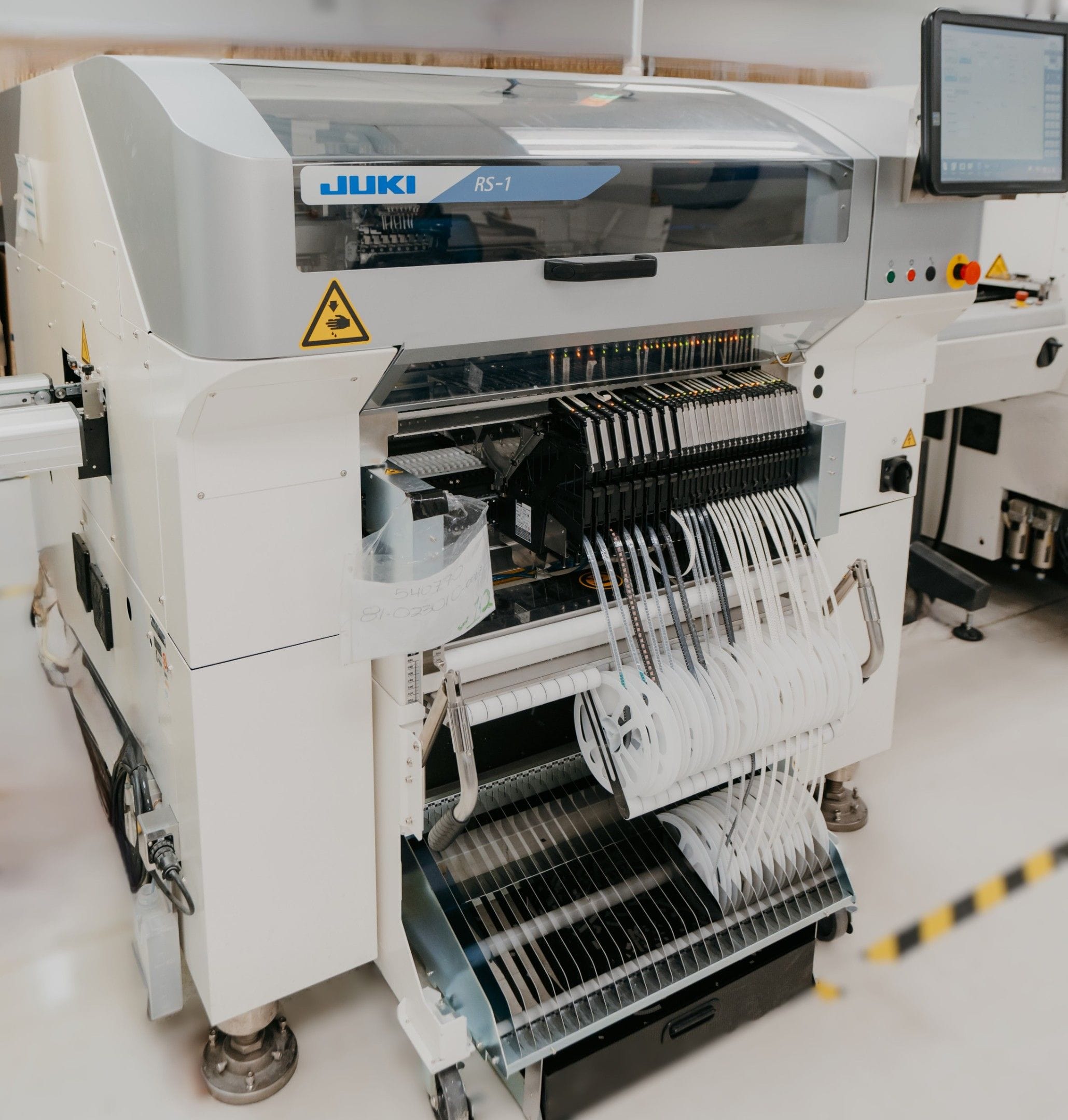 Juki RS-1 high speed SMT pick and place machine placing electronic components onto printed circuit boards during automated PCB assembly at IMS Electronics.
