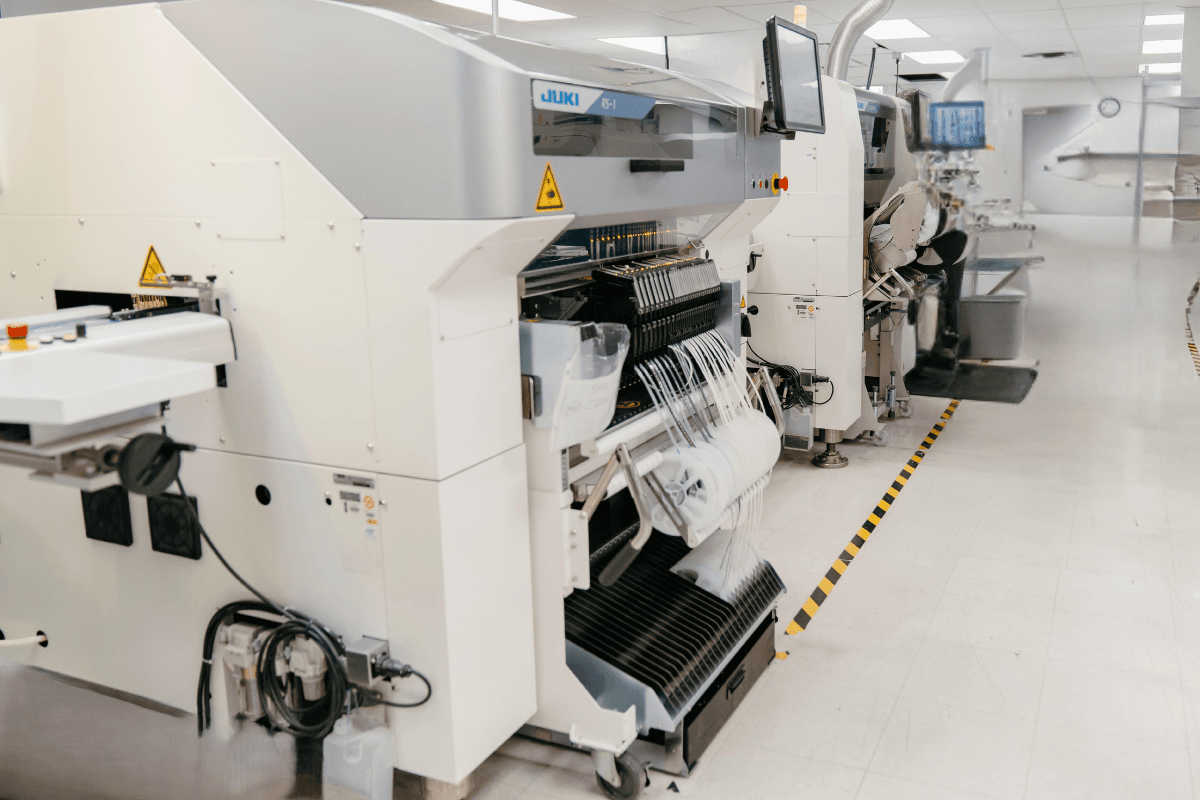 SMT pick-and-place line with loaded component feeder reels at IMS Electronics Manufacturing in Calgary